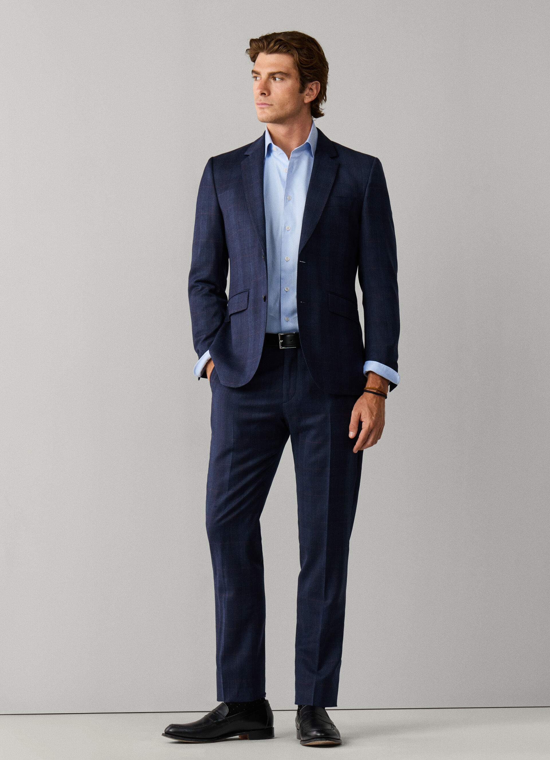 A grey Prince of Wales check flannel suit, shown on a model from the front.