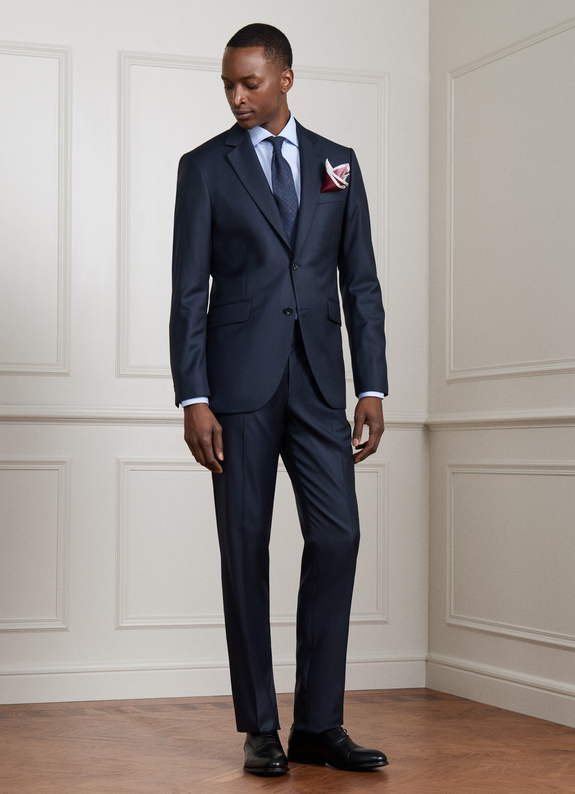 A navy birdseye-weave wool suit, shown on a model from the front.